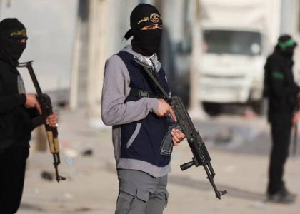 Armed Palestinian militants standing on a street in Gaza City.