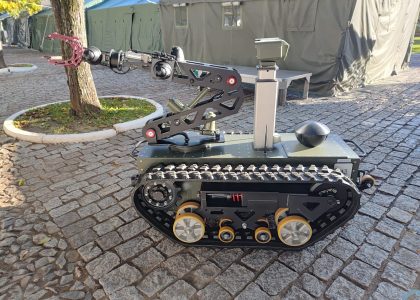 A remotely operated explosive ordnance disposal robot positioned during a military engineering demonstration.