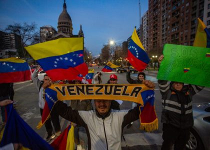 Venezuelan and Chilean flags displayed during a bilateral diplomatic meeting.