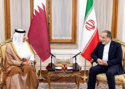 Qatari and Iranian officials meeting across a table in Tehran.